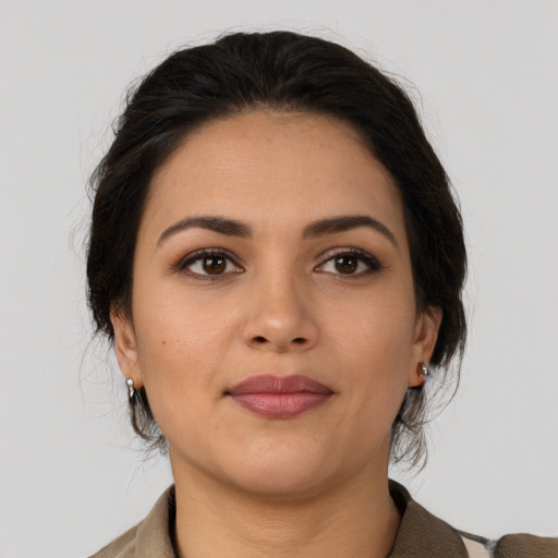 Joyful latino young-adult female with medium  brown hair and brown eyes