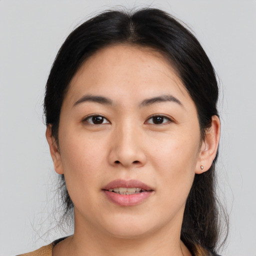 Joyful asian young-adult female with medium  brown hair and brown eyes