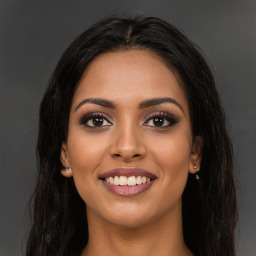 Joyful latino young-adult female with long  brown hair and brown eyes