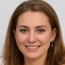 Joyful white young-adult female with long  brown hair and green eyes