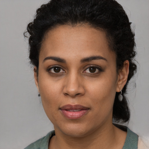 Joyful latino young-adult female with medium  black hair and brown eyes