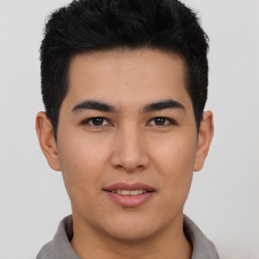 Joyful asian young-adult male with short  brown hair and brown eyes