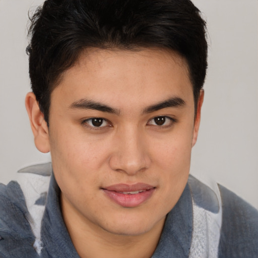 Joyful latino young-adult male with short  brown hair and brown eyes
