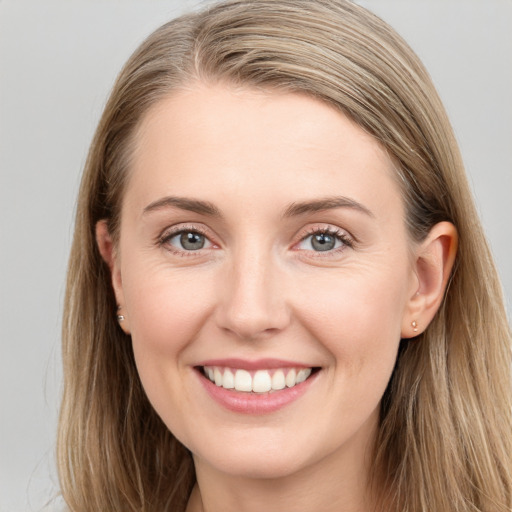 Joyful white young-adult female with long  brown hair and blue eyes