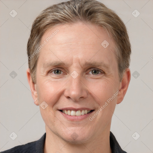 Joyful white adult male with short  brown hair and grey eyes