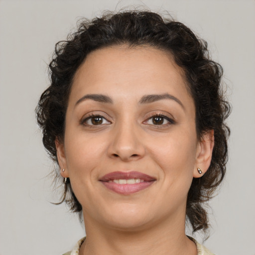 Joyful latino young-adult female with medium  brown hair and brown eyes