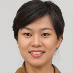 Joyful asian young-adult female with short  brown hair and brown eyes