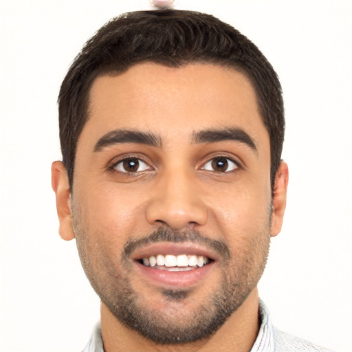 Joyful latino young-adult male with short  black hair and brown eyes