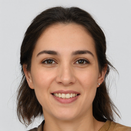 Joyful white young-adult female with medium  brown hair and brown eyes