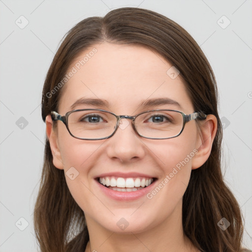 Joyful white young-adult female with long  brown hair and blue eyes