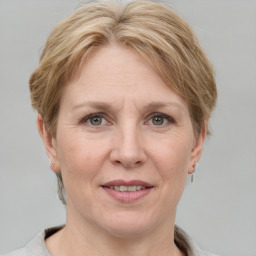 Joyful white adult female with short  brown hair and grey eyes