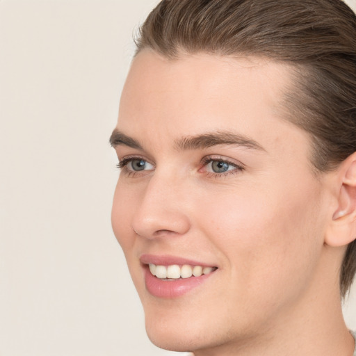 Joyful white young-adult female with short  brown hair and grey eyes