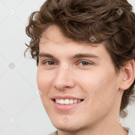 Joyful white young-adult male with medium  brown hair and brown eyes