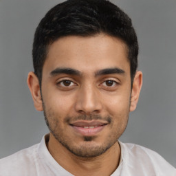 Joyful latino young-adult male with short  brown hair and brown eyes