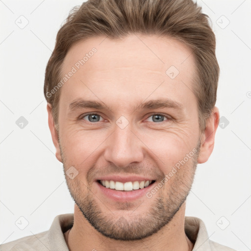 Joyful white young-adult male with short  brown hair and grey eyes