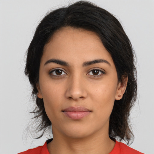 Joyful latino young-adult female with long  brown hair and brown eyes