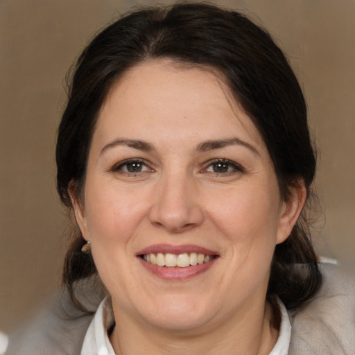 Joyful white adult female with medium  brown hair and brown eyes