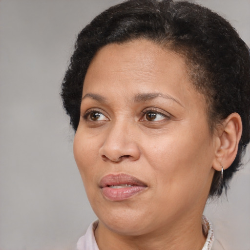 Joyful black adult female with short  brown hair and brown eyes