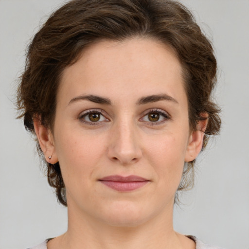 Joyful white young-adult female with medium  brown hair and green eyes