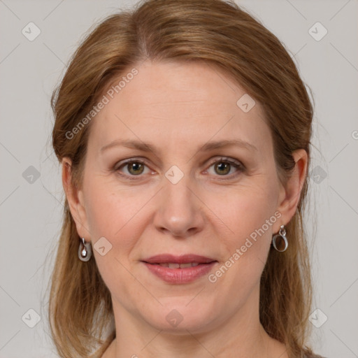 Joyful white adult female with long  brown hair and grey eyes