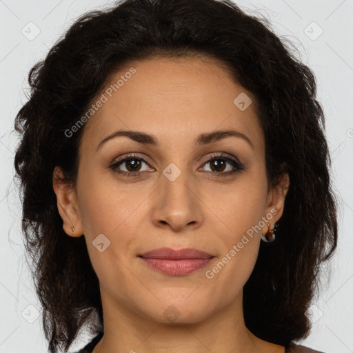 Joyful white adult female with long  brown hair and brown eyes