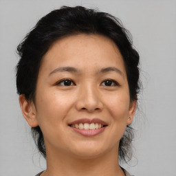 Joyful asian young-adult female with short  brown hair and brown eyes