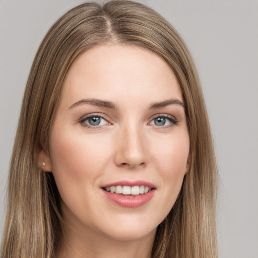 Joyful white young-adult female with long  brown hair and grey eyes