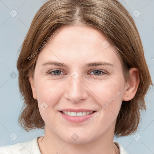 Joyful white young-adult female with medium  brown hair and blue eyes