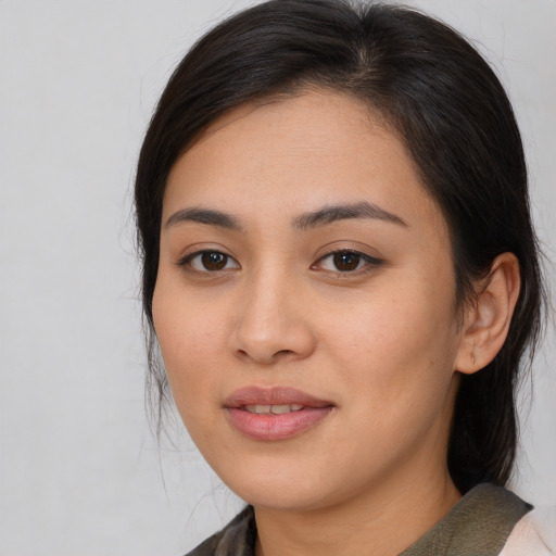 Joyful white young-adult female with medium  brown hair and brown eyes