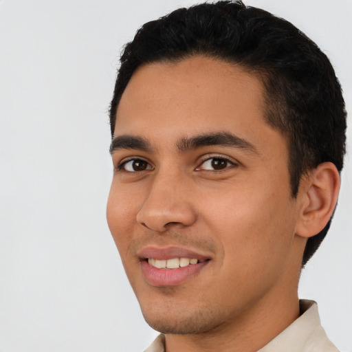 Joyful latino young-adult male with short  black hair and brown eyes