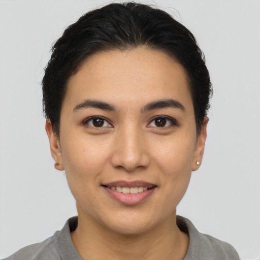 Joyful white young-adult female with short  brown hair and brown eyes