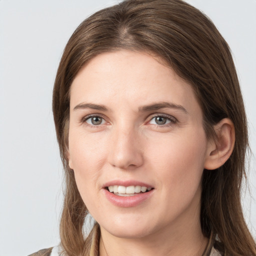 Joyful white young-adult female with long  brown hair and grey eyes