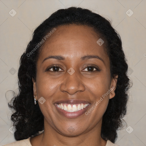 Joyful black adult female with long  brown hair and brown eyes