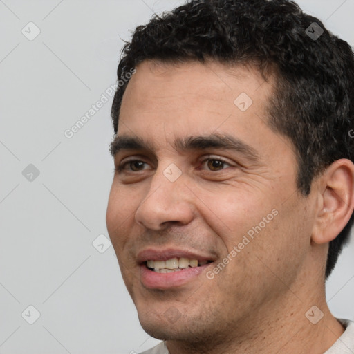 Joyful white young-adult male with short  black hair and brown eyes