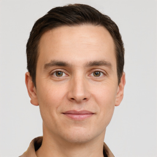 Joyful white young-adult male with short  brown hair and brown eyes