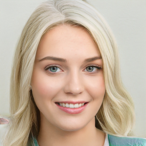 Joyful white young-adult female with long  brown hair and blue eyes