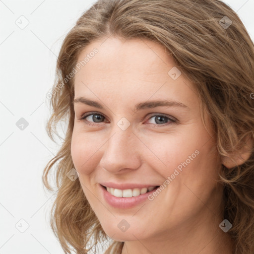 Joyful white young-adult female with medium  brown hair and green eyes