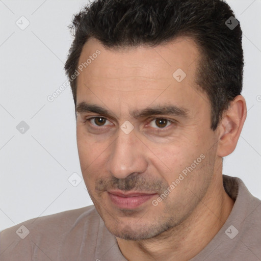 Joyful white adult male with short  brown hair and brown eyes