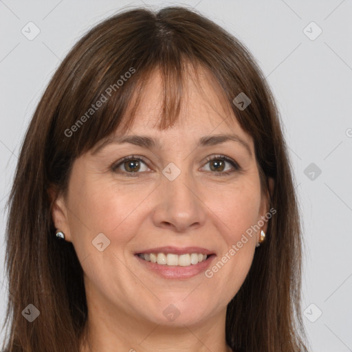 Joyful white adult female with long  brown hair and grey eyes