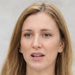 Joyful white young-adult female with long  brown hair and green eyes