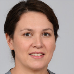 Joyful white adult female with medium  brown hair and brown eyes