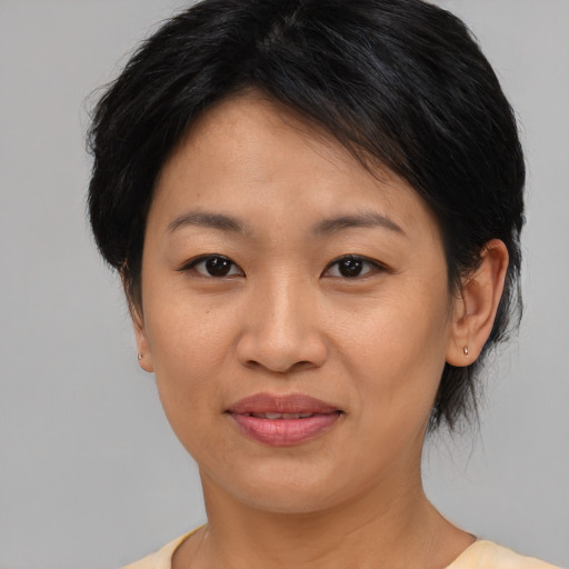 Joyful asian young-adult female with medium  brown hair and brown eyes