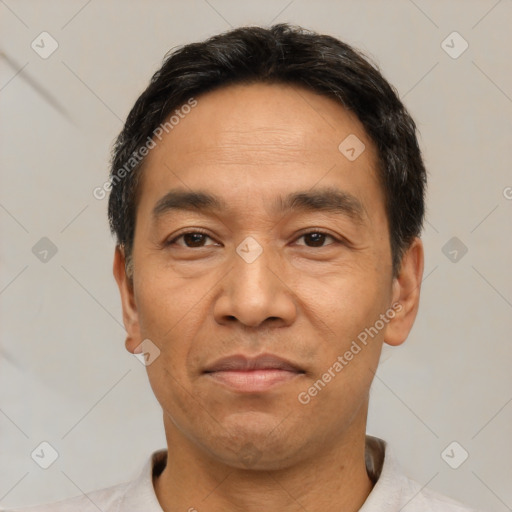 Joyful white adult male with short  black hair and brown eyes