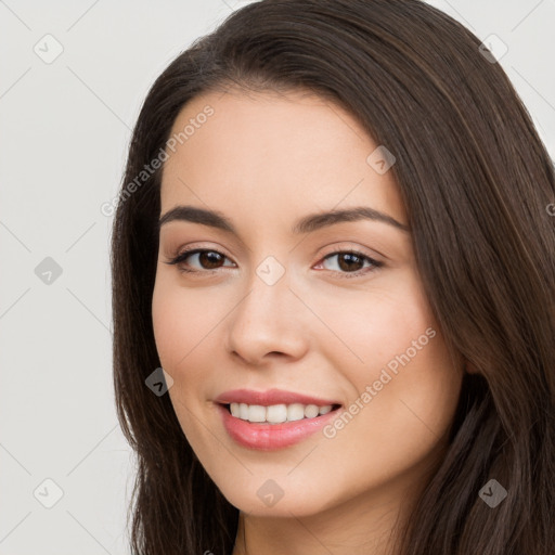 Joyful white young-adult female with long  brown hair and brown eyes