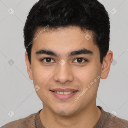 Joyful latino young-adult male with short  black hair and brown eyes