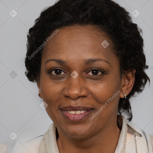 Joyful black adult female with medium  brown hair and brown eyes