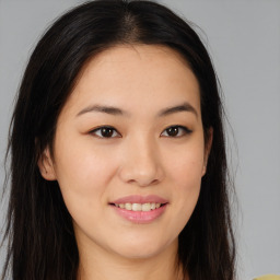 Joyful asian young-adult female with long  brown hair and brown eyes