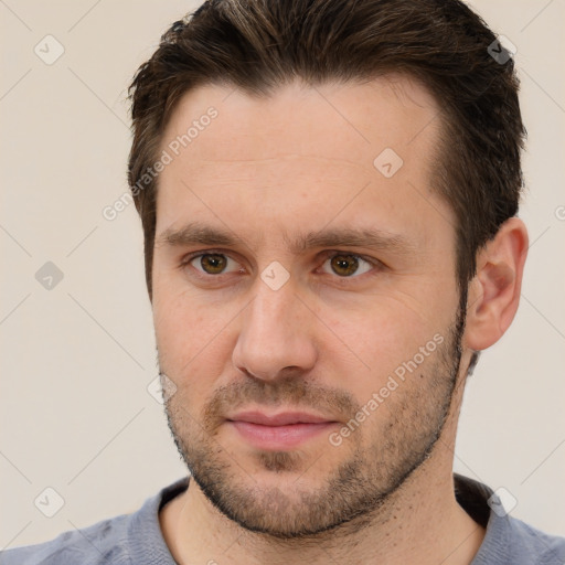 Joyful white young-adult male with short  brown hair and brown eyes