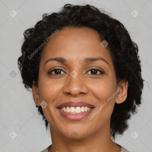 Joyful black adult female with medium  brown hair and brown eyes