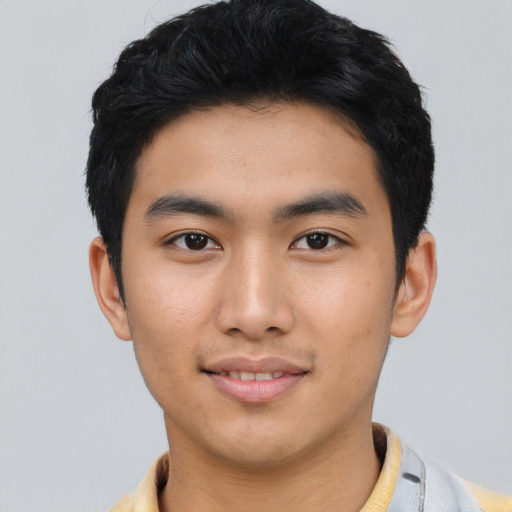 Joyful asian young-adult male with short  black hair and brown eyes